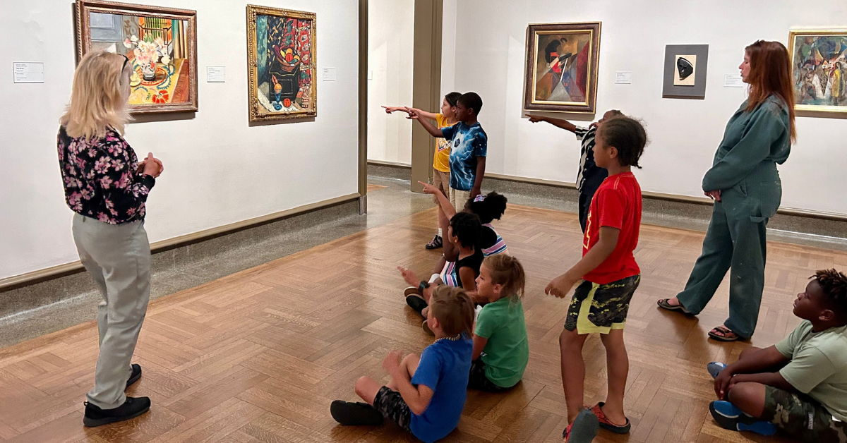 students pointing at artwork